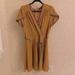 Smak Parlour mustard faux-wrap dress with blue and white trim.